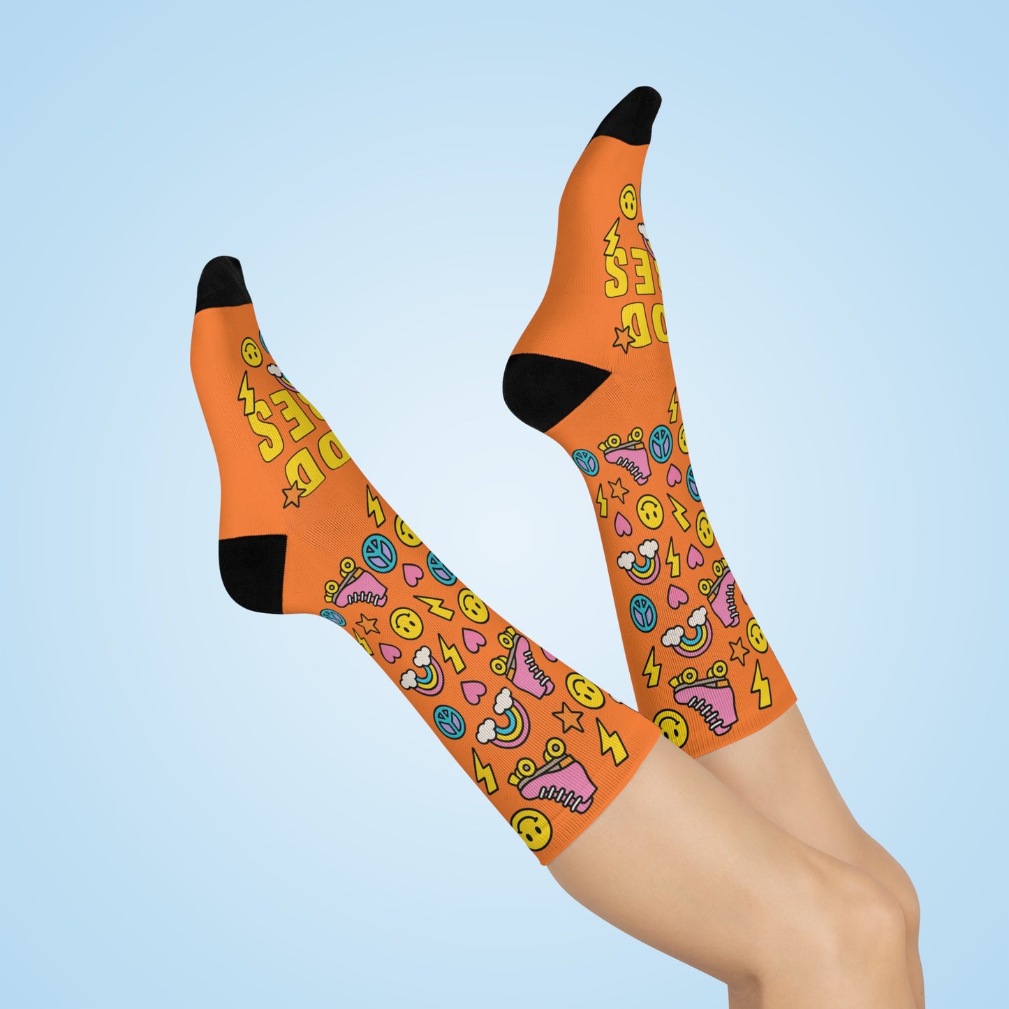 Orange knee-high socks with colorful patterns on a light blue background