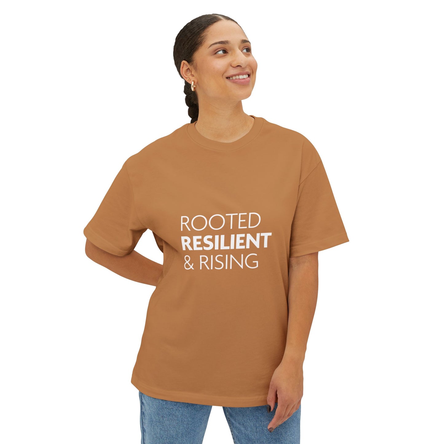 Person wearing a brown t-shirt with 'ROOTED RESILIENT & RISING' text on a white background