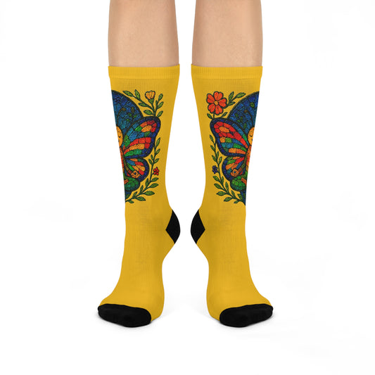 Yellow socks with colorful butterfly design on a white background