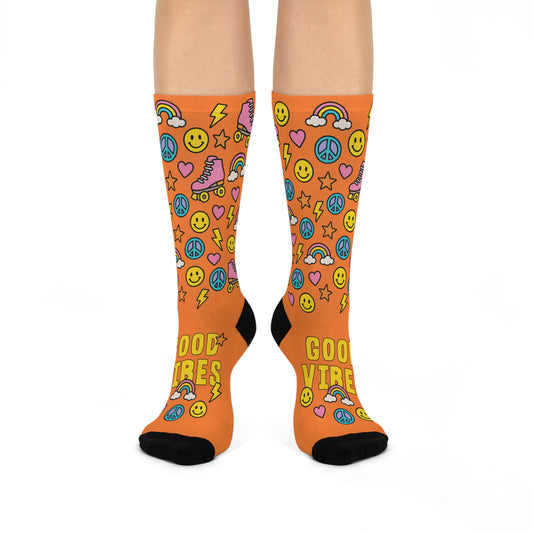 Orange socks with colorful patterns and 'Good Vibes' text on a white background