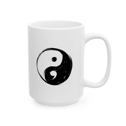 White mug with a black yin yang symbol on a white background