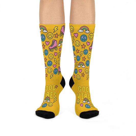 Yellow socks with colorful patterns and text on a white background